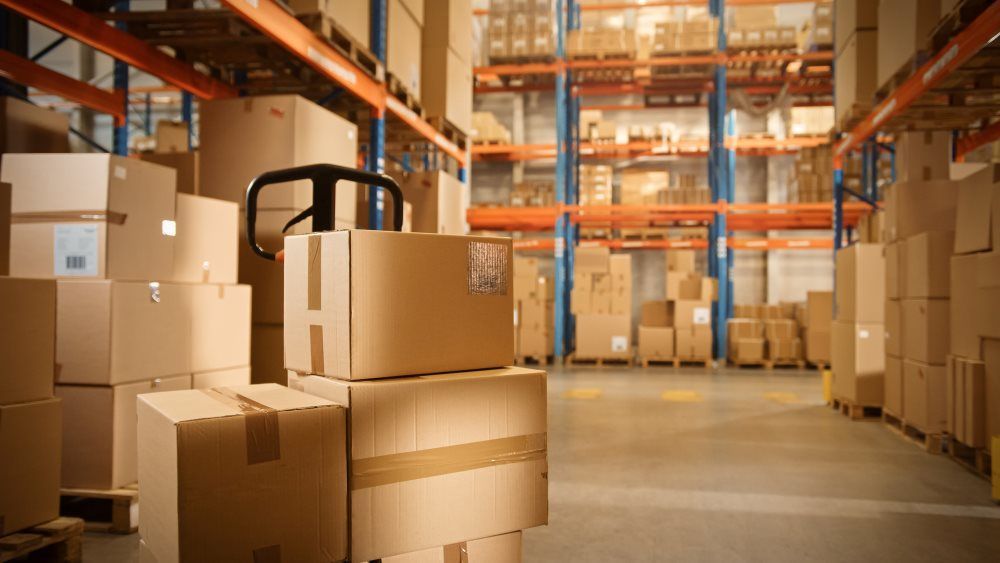 A Warehouse Filled With Cardboard Boxes and Shelves — Kingaroy Self Storage Sheds in Kingaroy, QLD