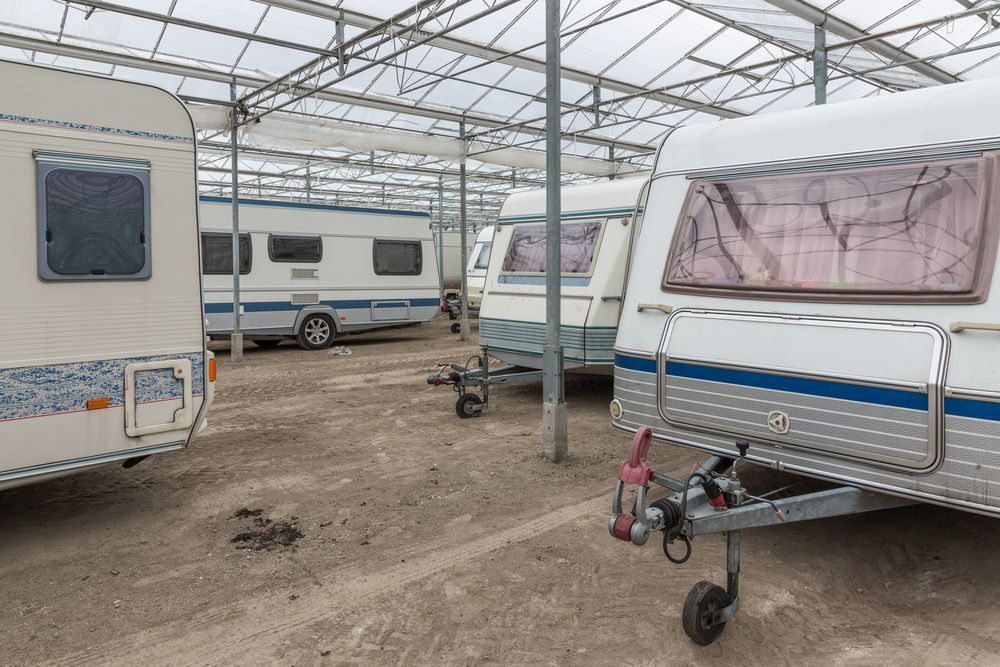 A Row of Caravans Are Parked in a Greenhouse — Kingaroy Self Storage Sheds in Kingaroy, QLD