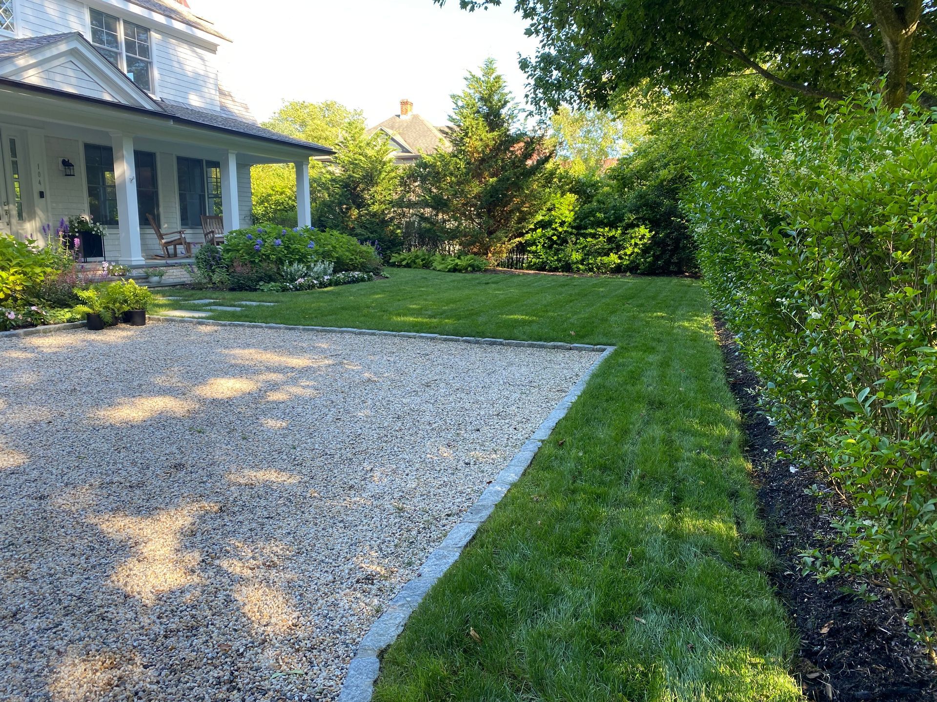 A house with a gravel driveway leading to it
