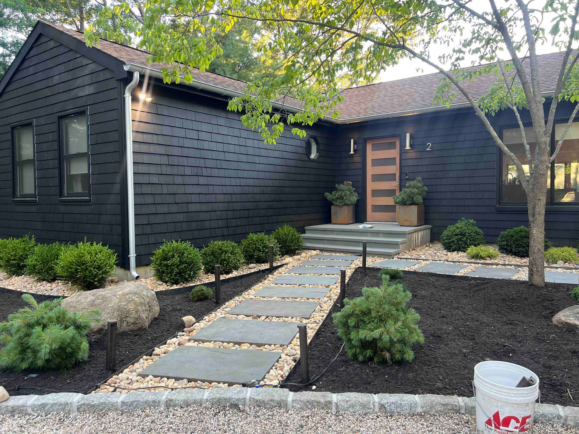 A house with a gravel driveway leading to it