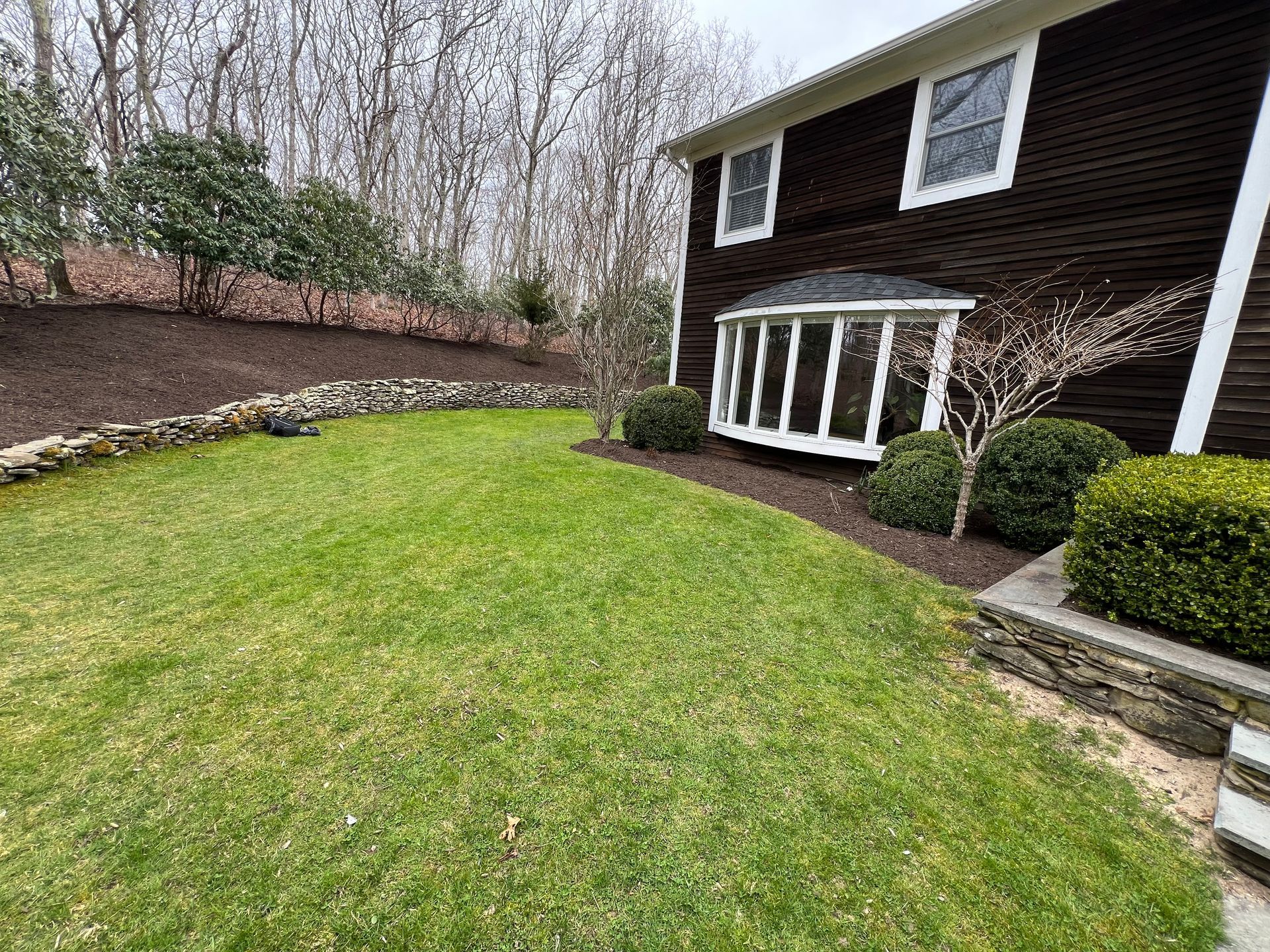 A large house with a large lawn in front of it.