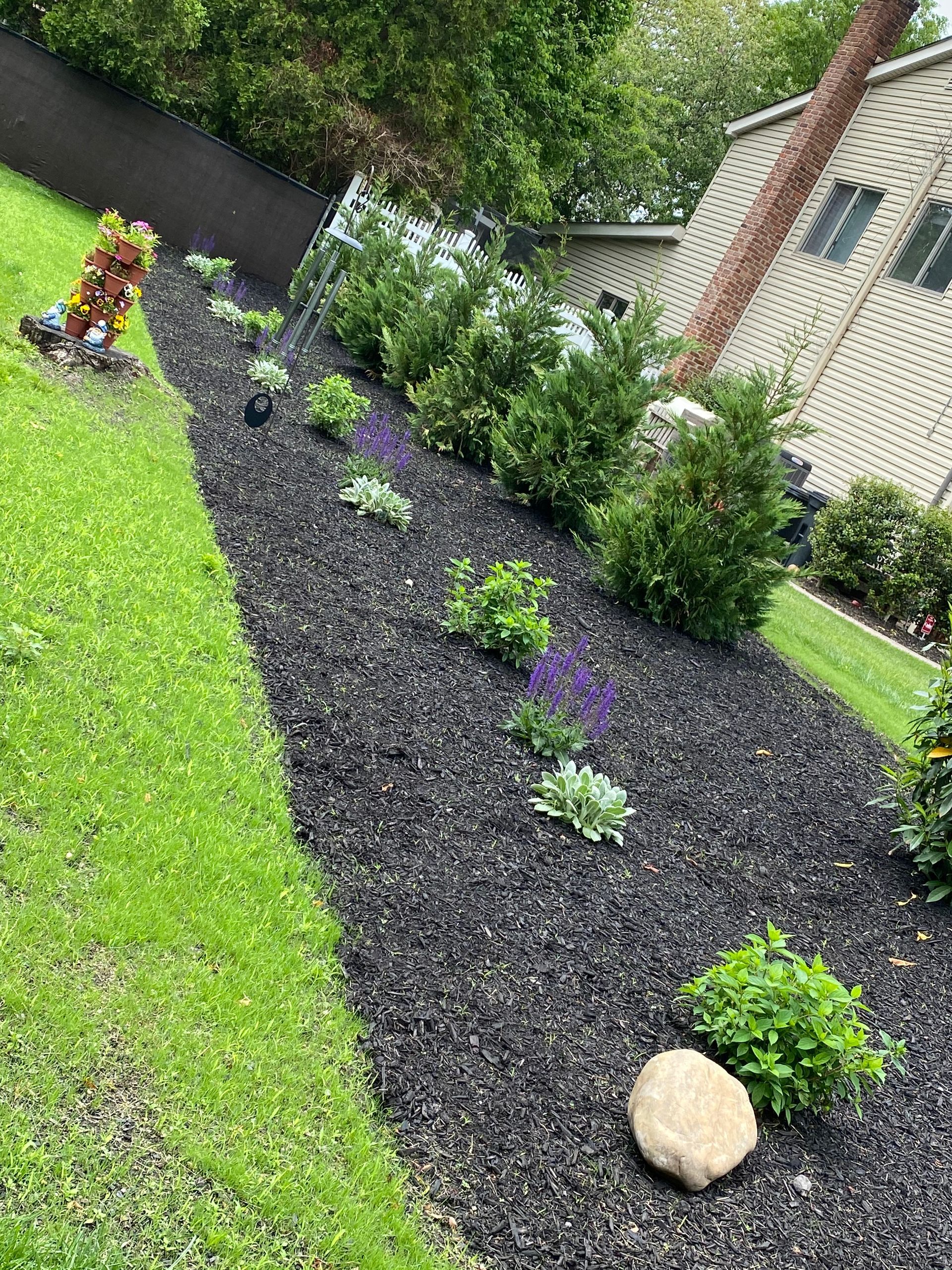 There is a rock in the middle of the garden.