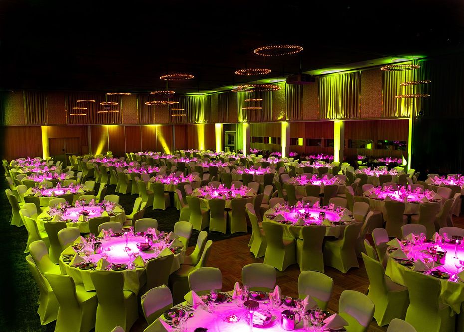 A large room with tables and chairs set up for a party