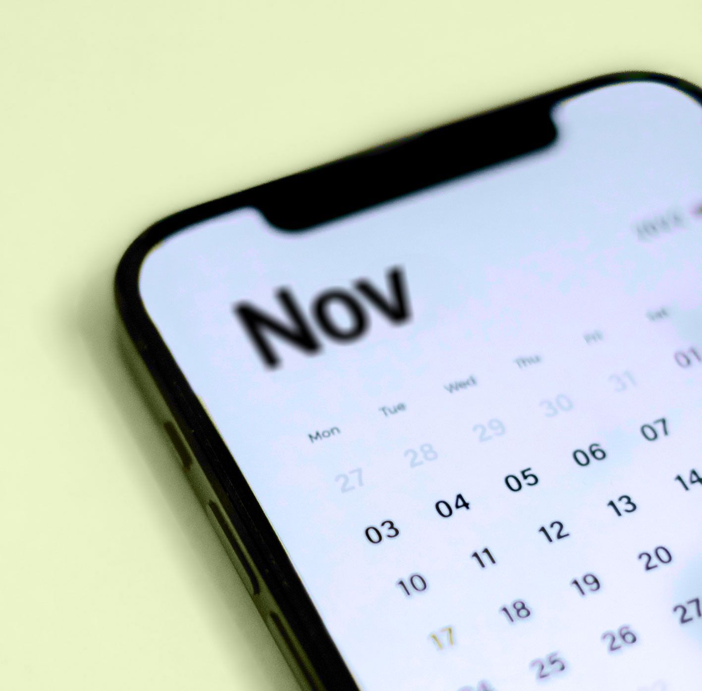 A cell phone displays a calendar for november