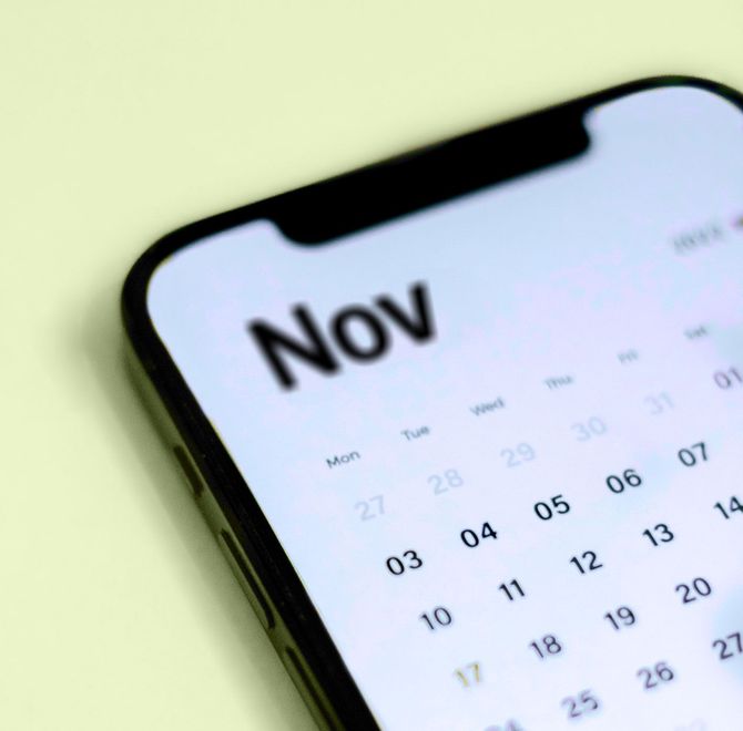 A cell phone displays a calendar for november