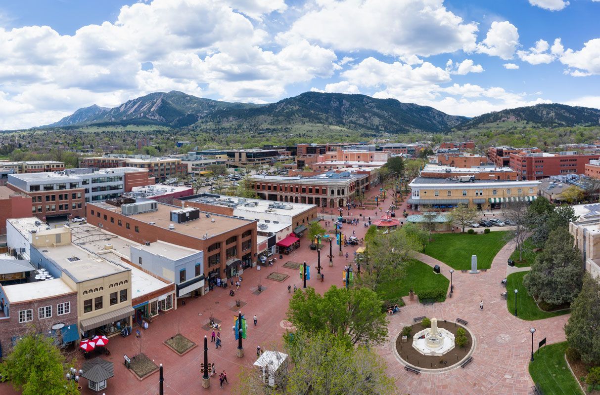 An aerial view of a city with mountains in the background.