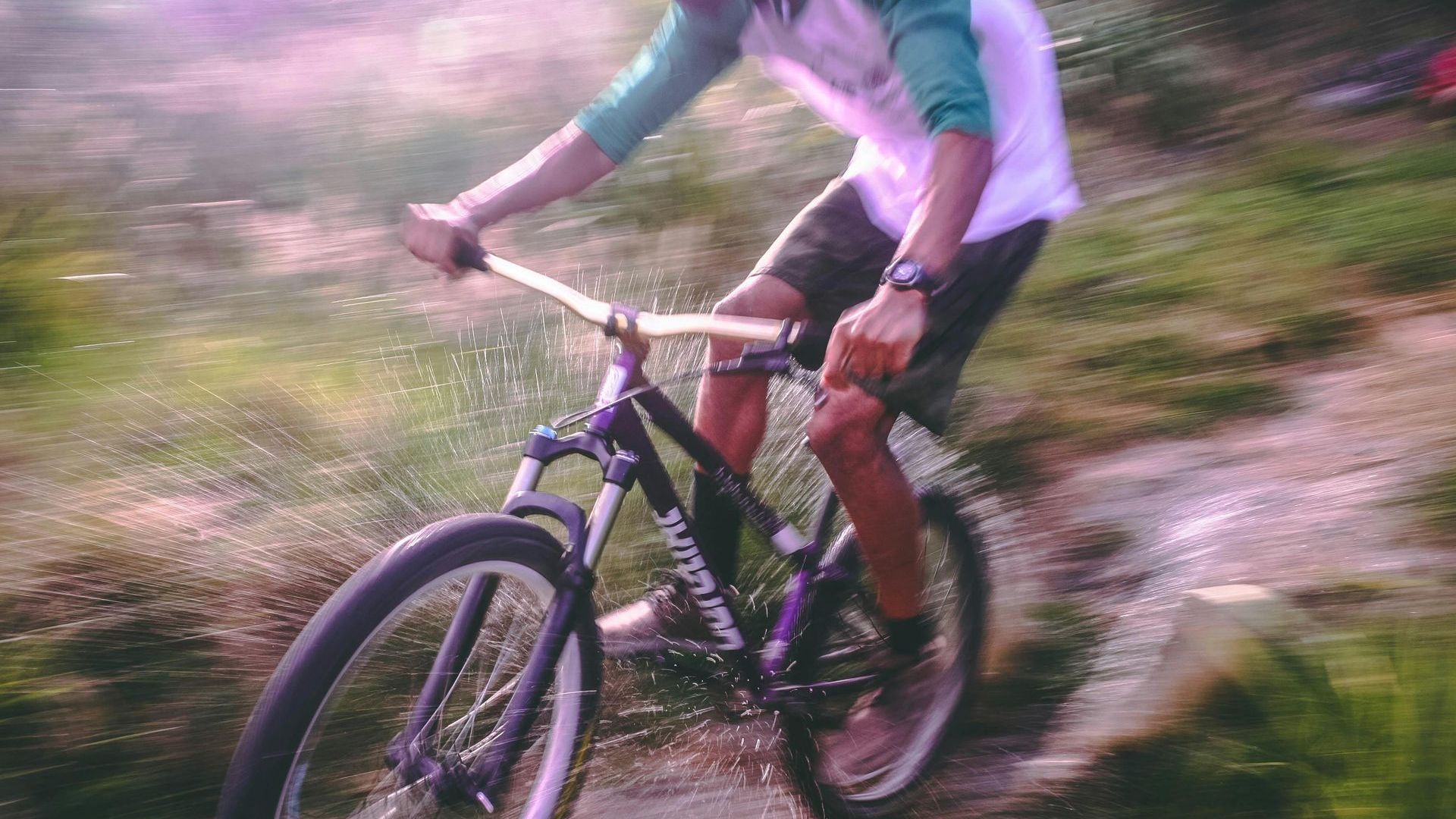 A man is riding a bike down a trail.