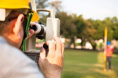 Surveyor engineer with partner making measure - Surveying Services in Stuarts Draft, VA