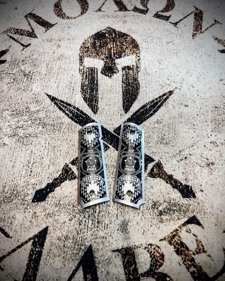 A pair of pistol grips with a spartan helmet on them