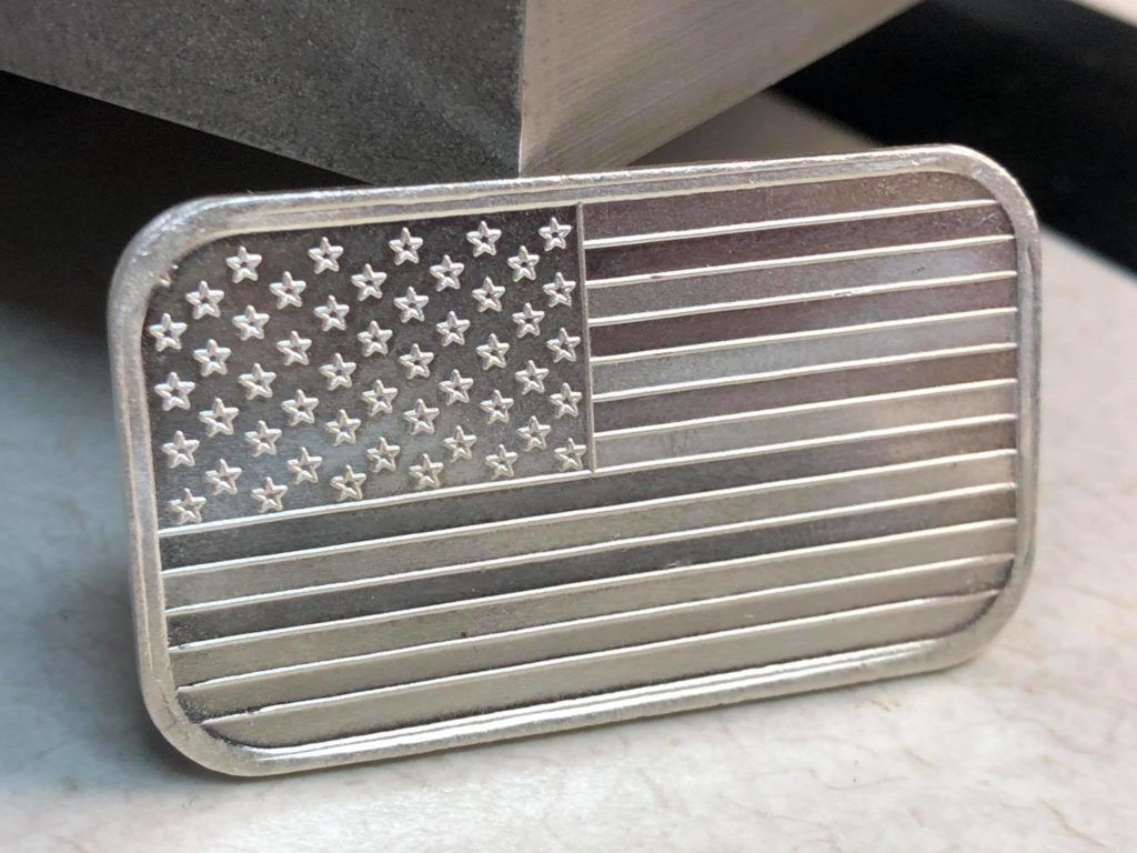 A silver belt buckle with an american flag on it