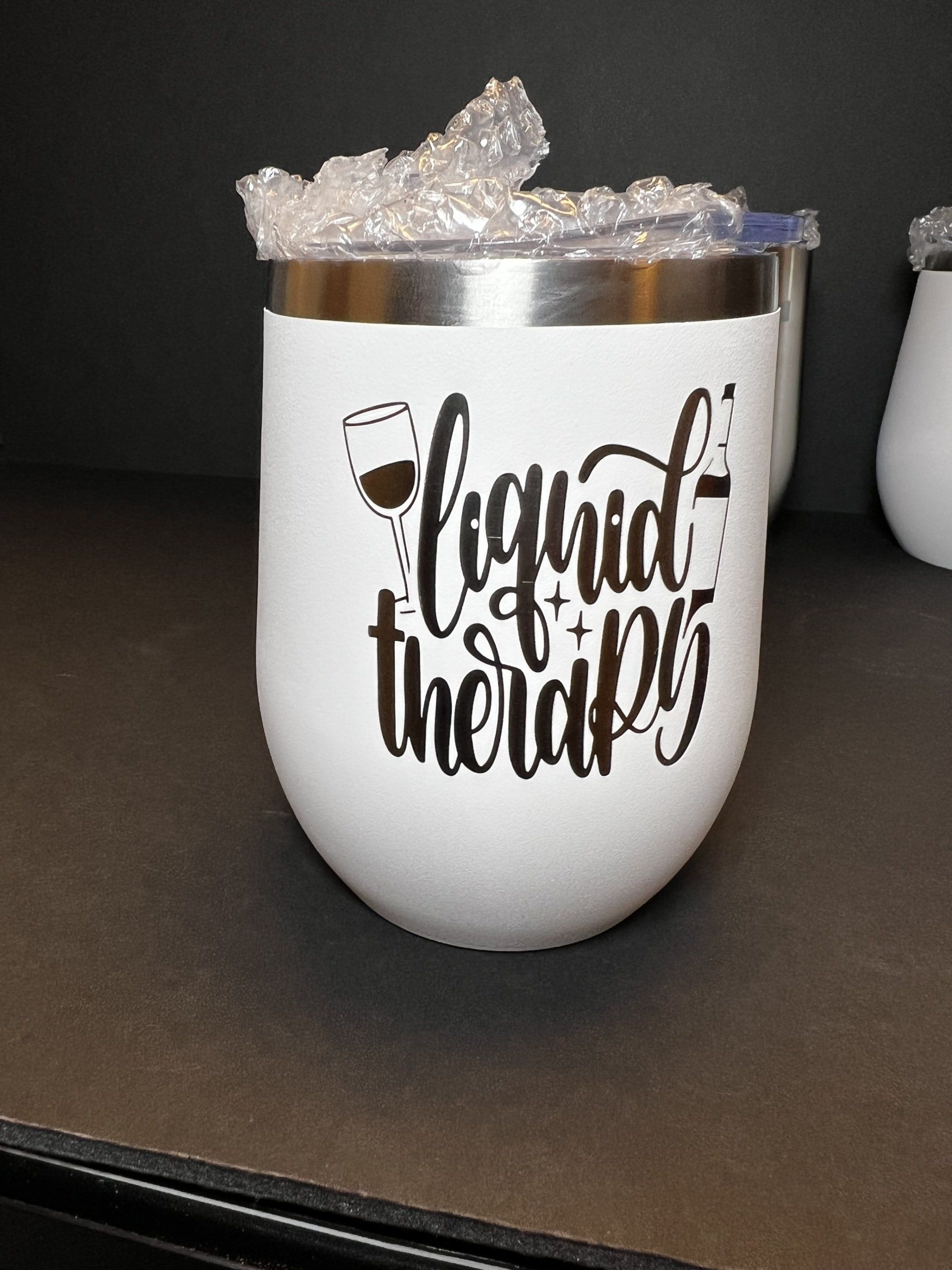 A wine glass that says liquid therapy on it