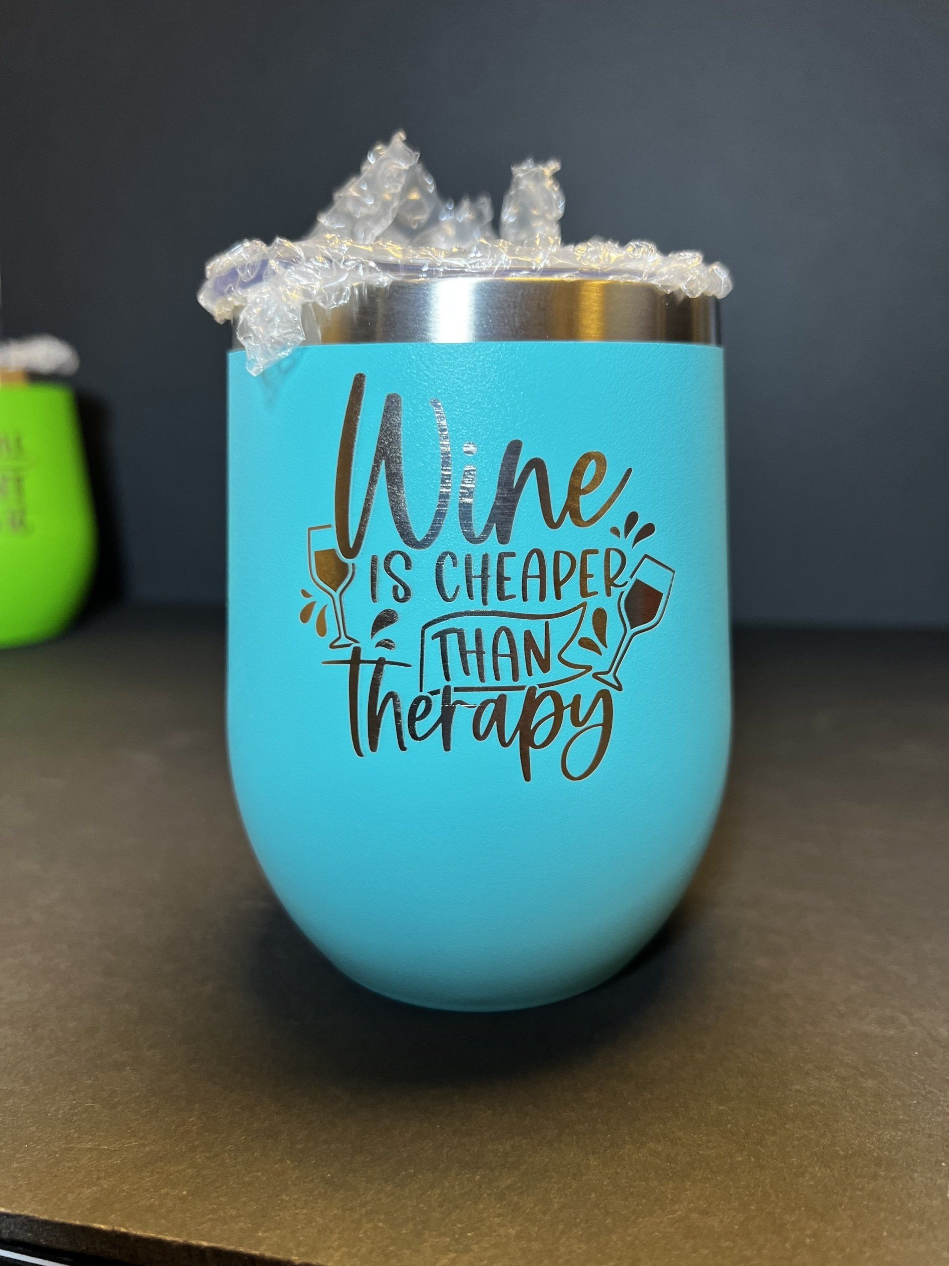 A wine tumbler that says wine is cheaper than therapy