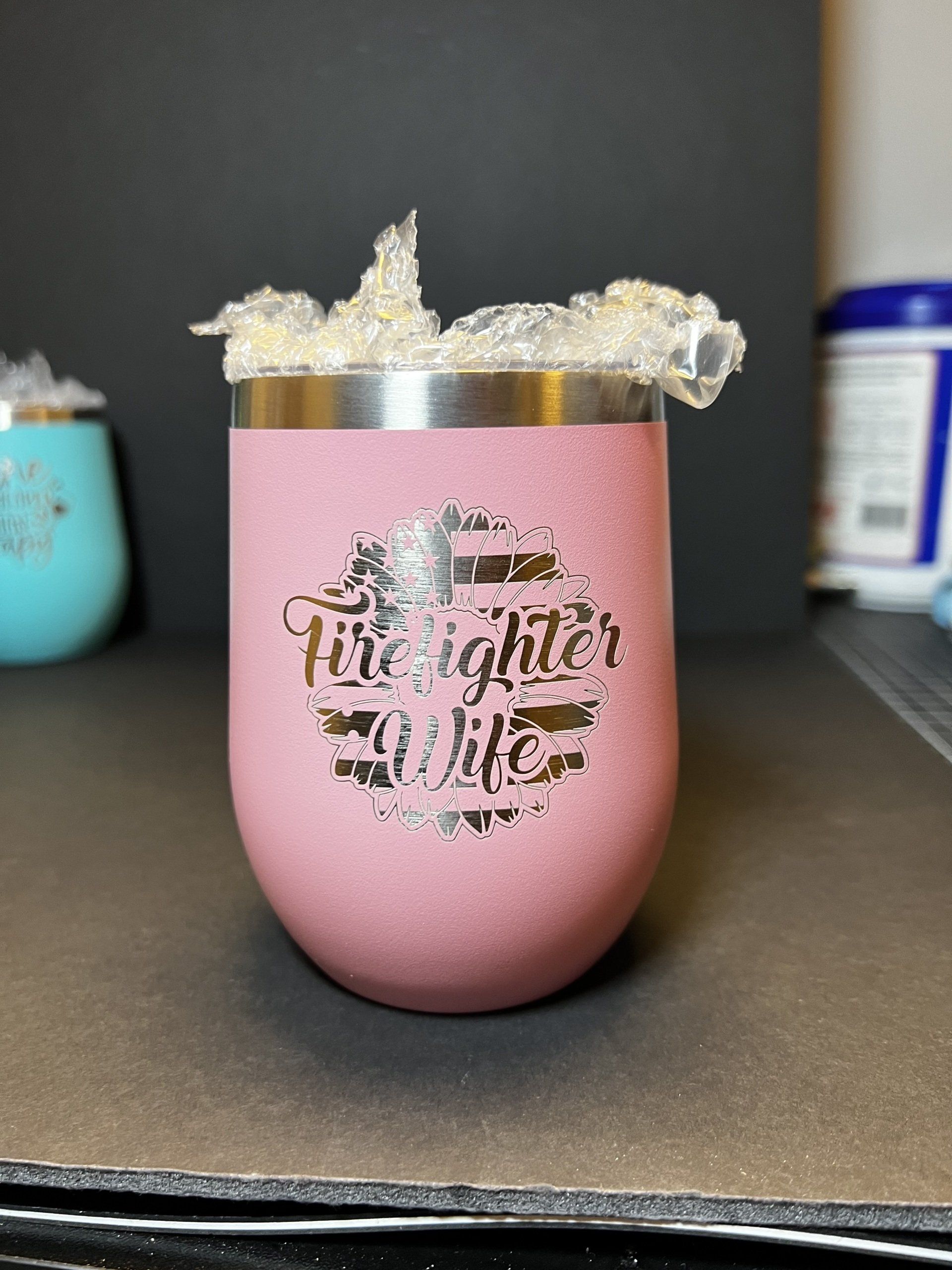 A pink tumbler with the words