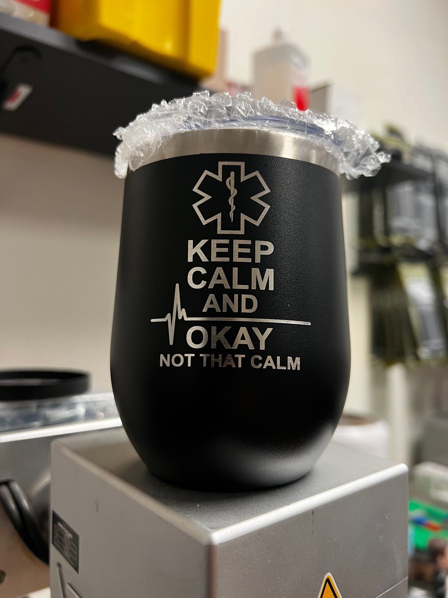 A black tumbler that says `` keep calm and okay not that calm ''