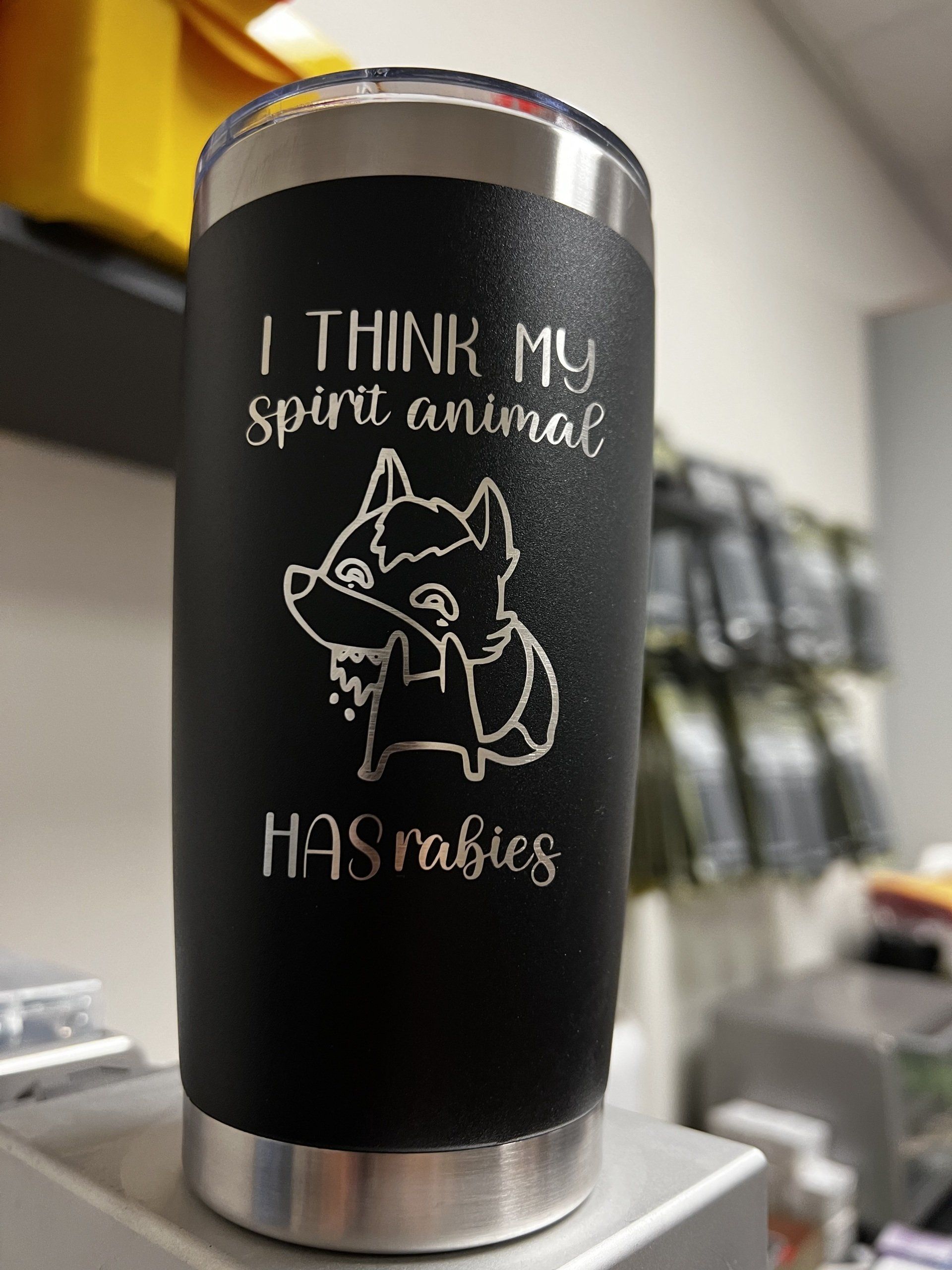 A stainless steel tumbler with a wolf on it that says `` i think my spirit animal has rabies ''