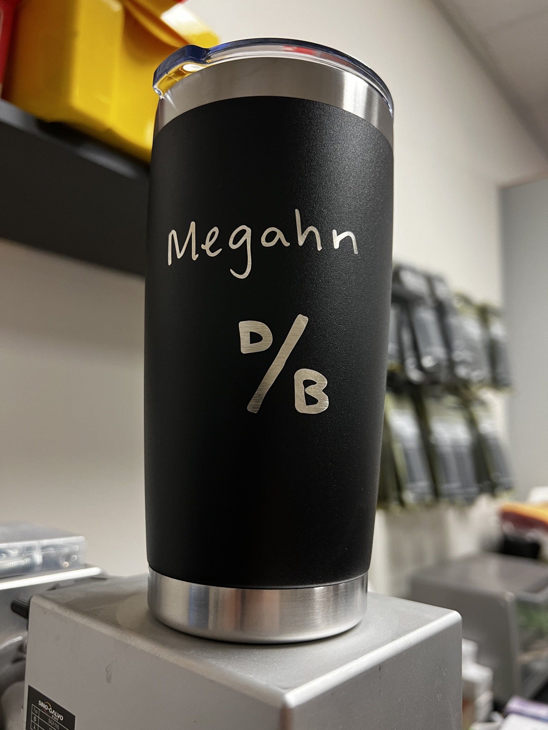 A black tumbler with the name megahn written on it