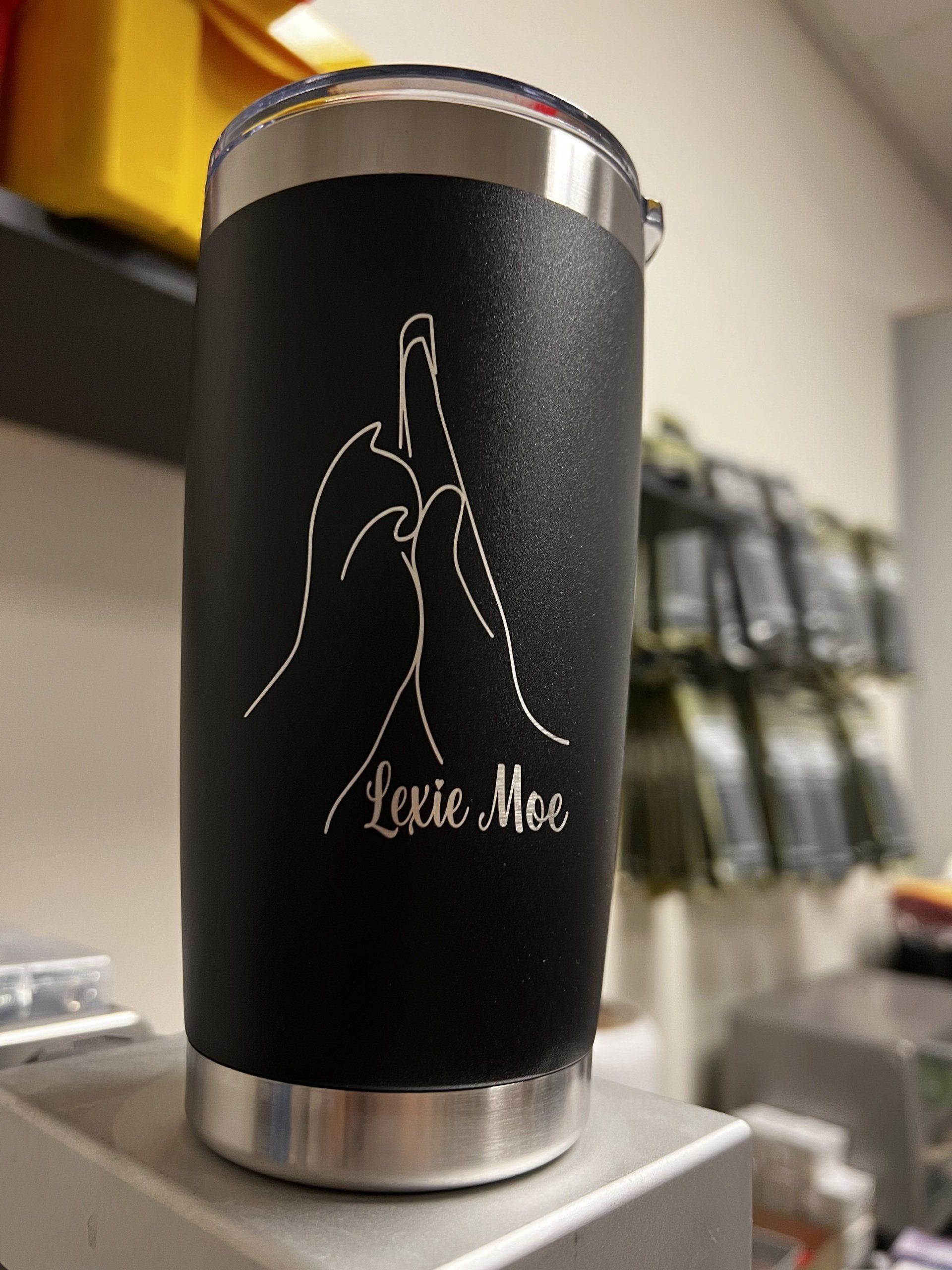 A black tumbler with the name lexie mac on it