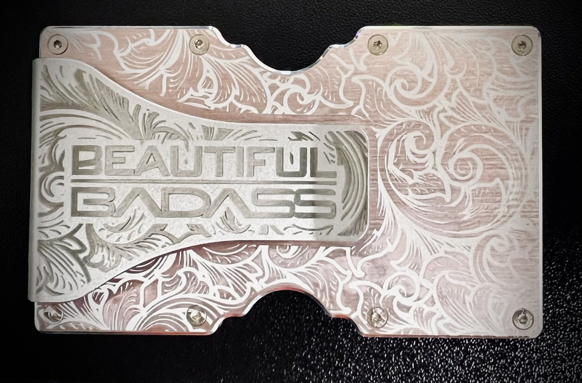 A wallet with the words beautiful badass engraved on it