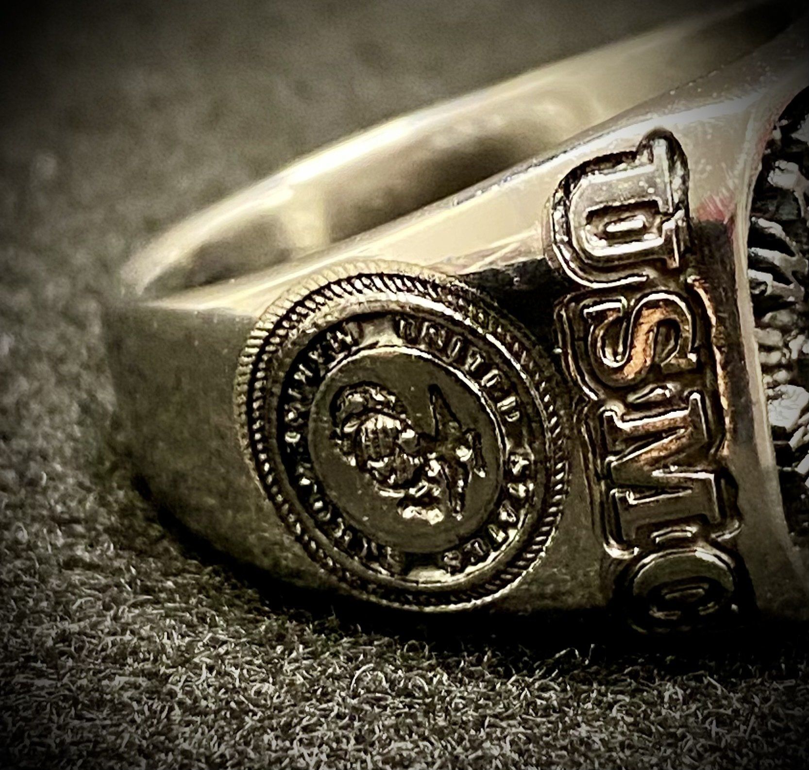 A silver ring with the word usmc on it