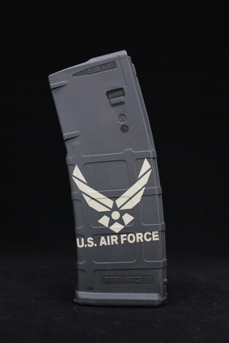 A u.s. air force magazine is sitting on a black surface.