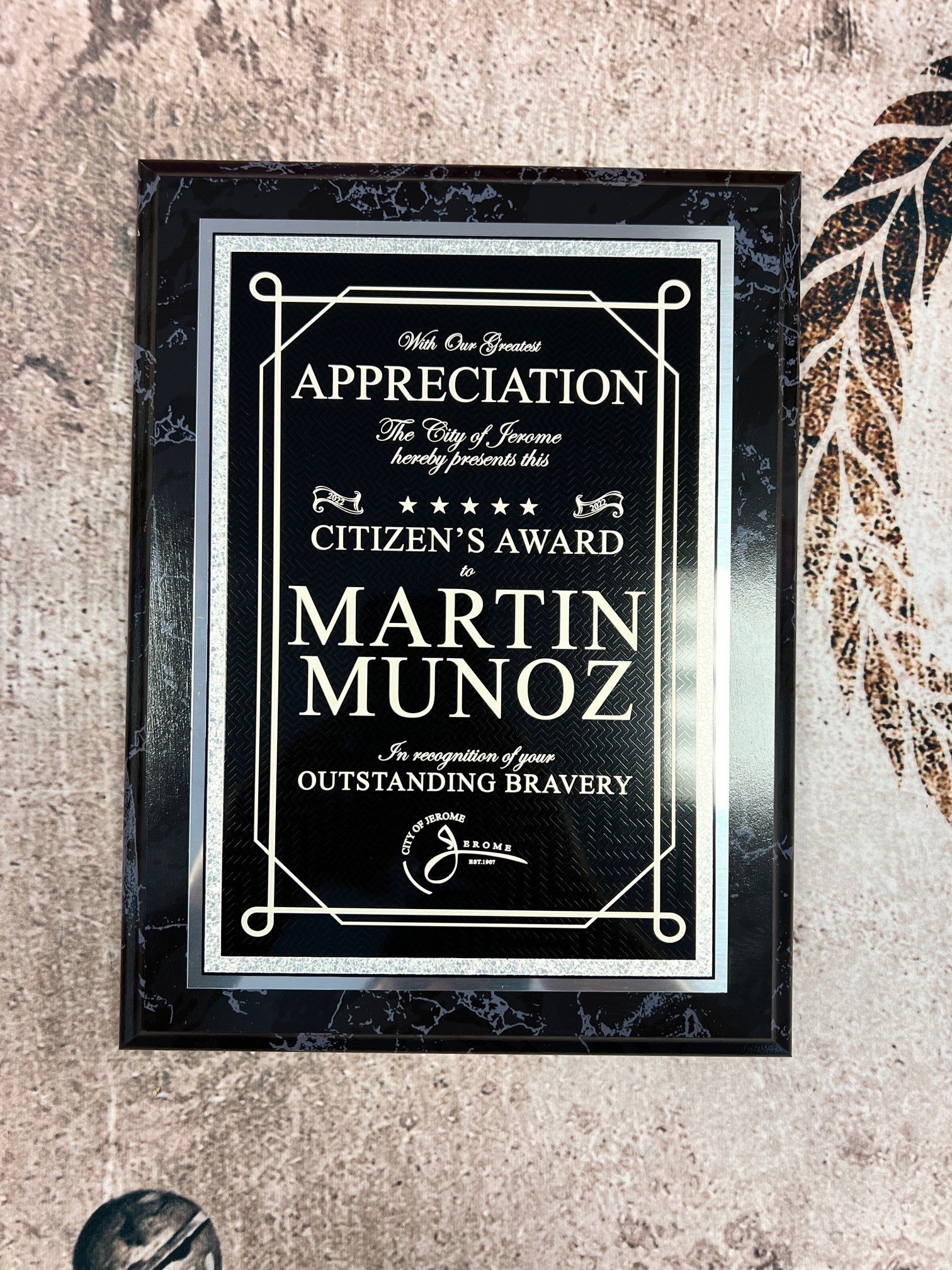 A black and silver plaque with the name martin munoz on it.