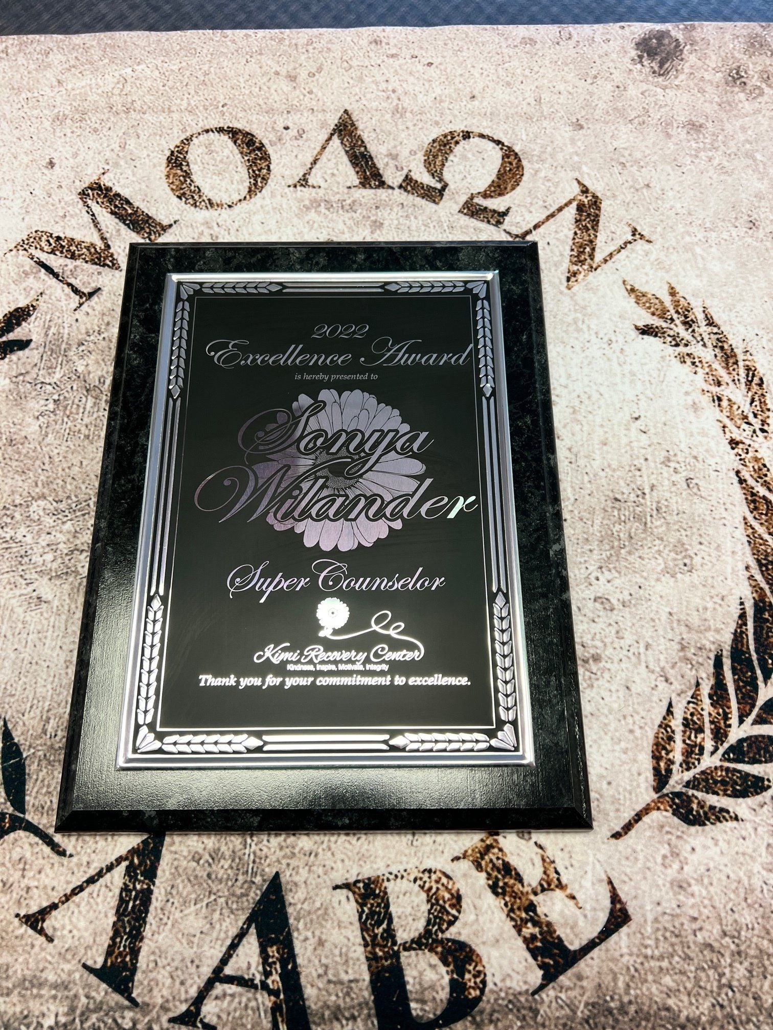 A framed certificate is sitting on top of a table.