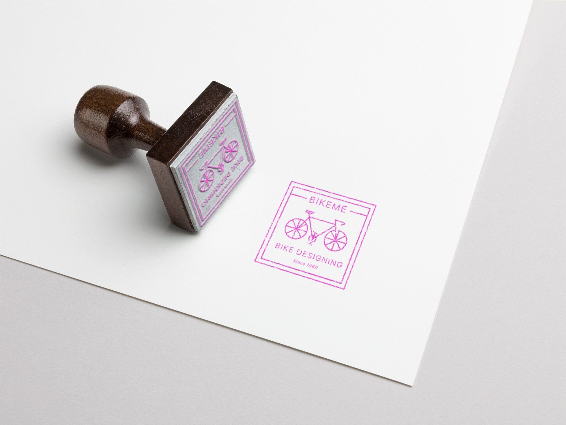 A stamp with a picture of a bicycle on it is sitting on top of a piece of paper.