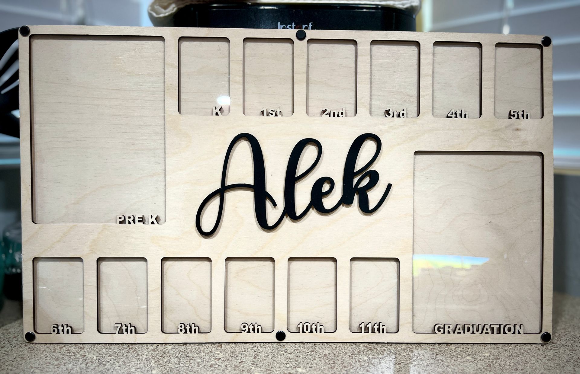 A wooden sign with the name alek on it