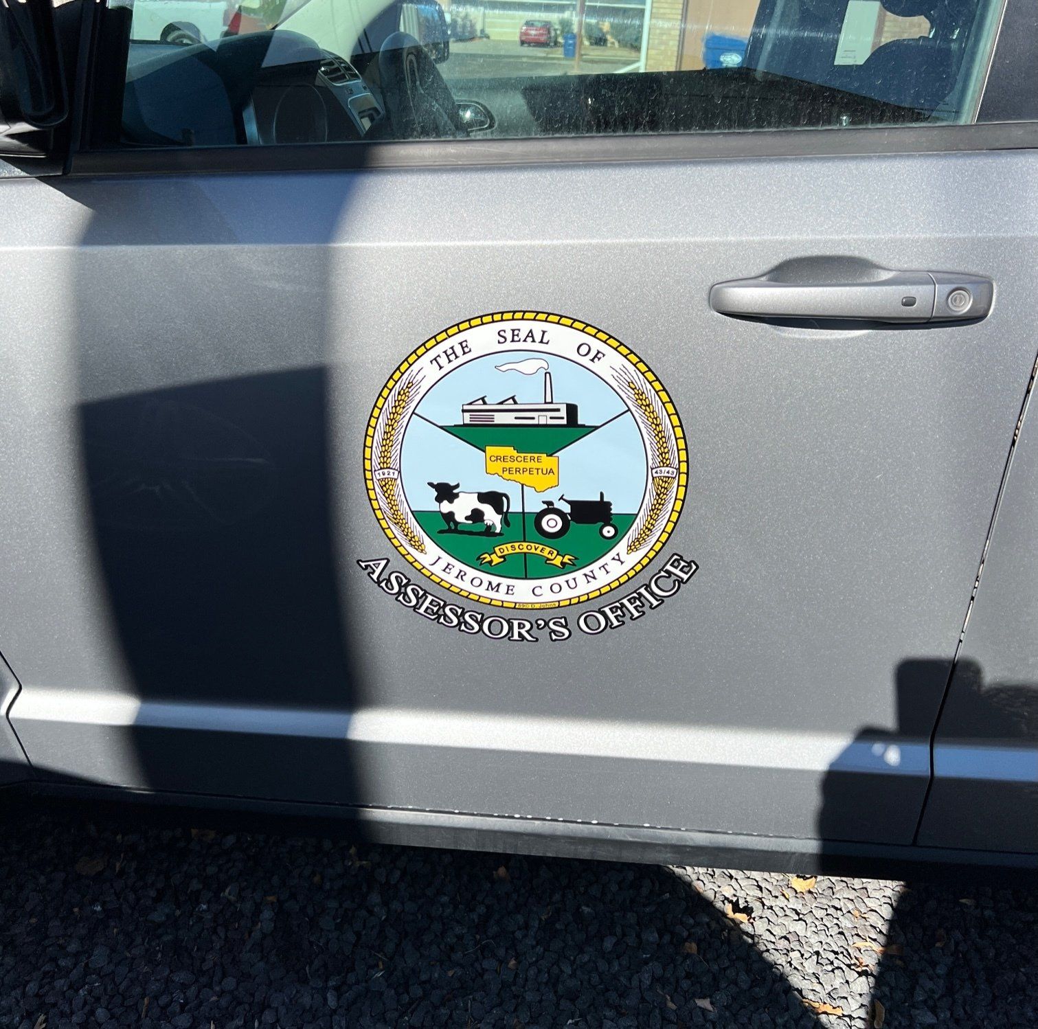 A car with a sticker on the side that says ' assessor 's office '