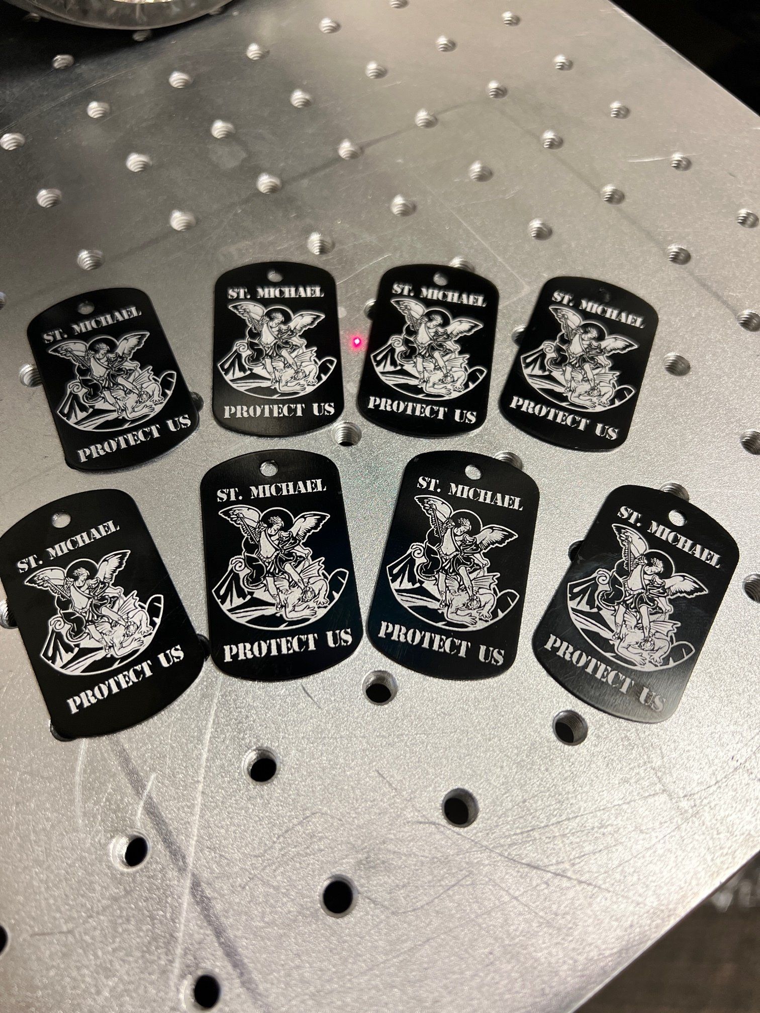 A bunch of dog tags are sitting on top of a metal table.