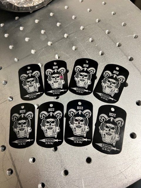 A bunch of dog tags with skulls on them