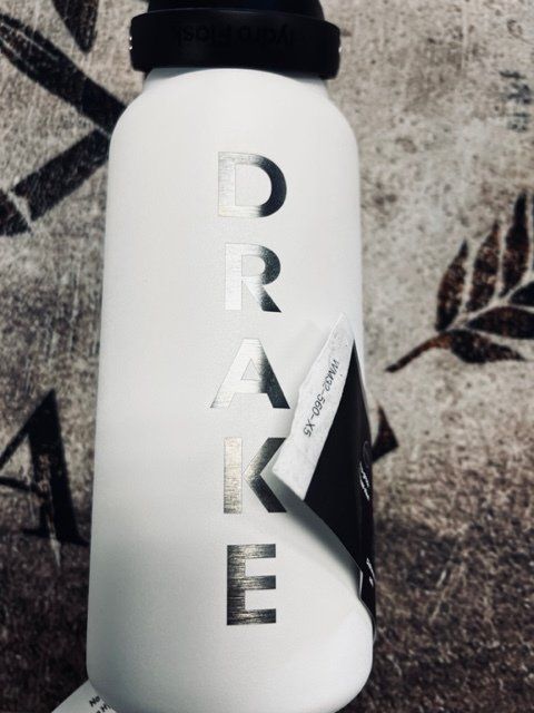 A white water bottle with the word drake on it