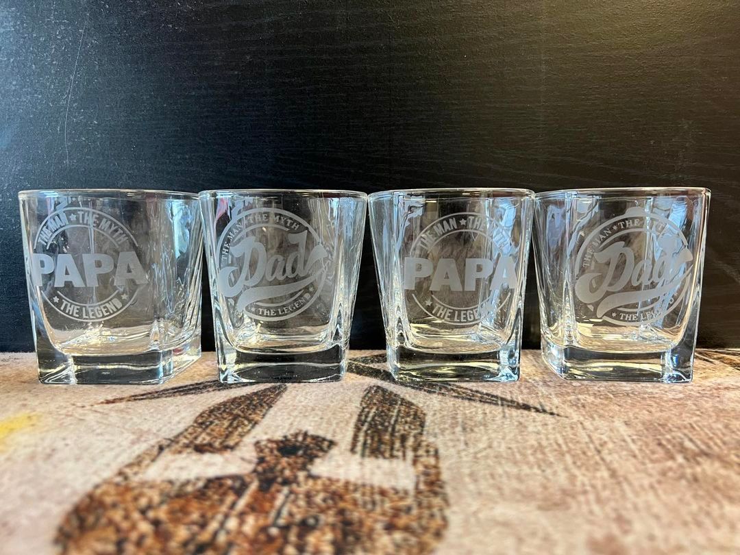 A set of four shot glasses sitting on top of a table.