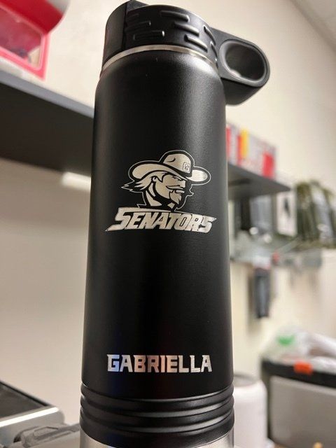 A black senators water bottle with gabriella written on it