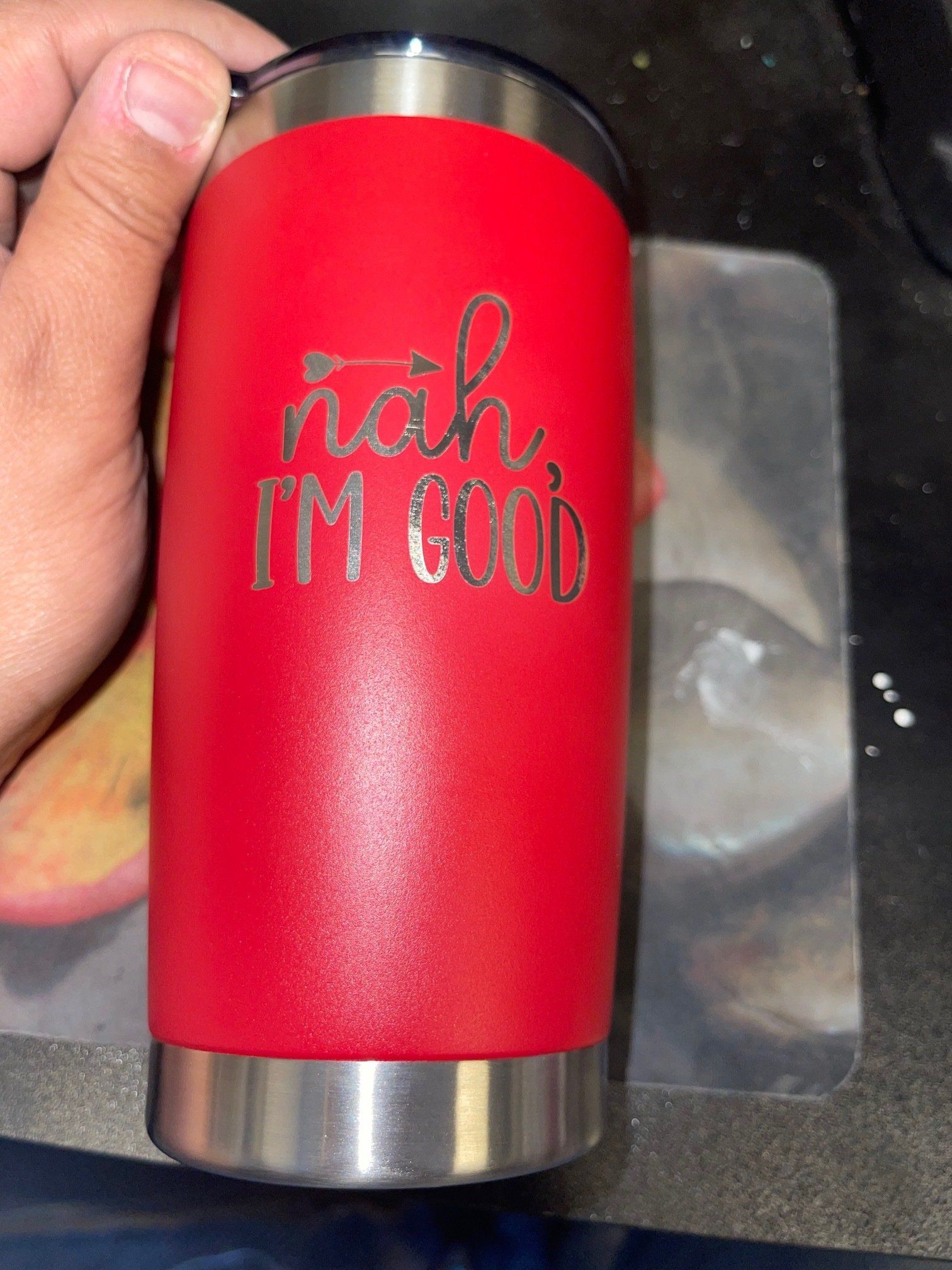 A person is holding a red tumbler that says `` nah , i 'm good ''.