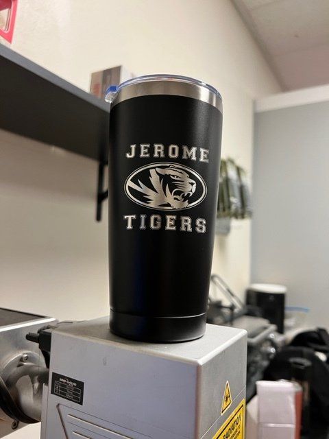 A black tumbler that says jerome tigers on it
