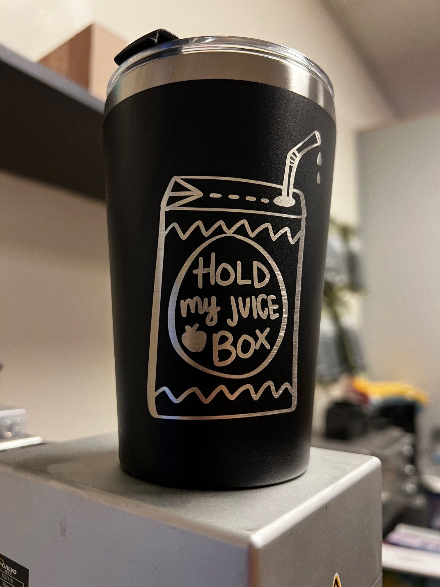 A black tumbler that says hold my juice box