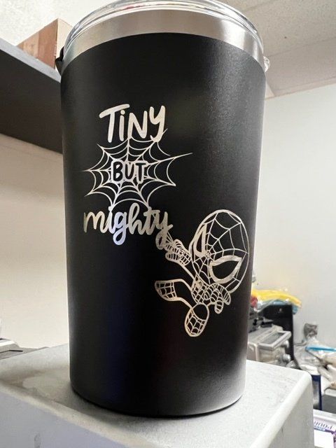 A black tumbler with the words tiny but mighty on it