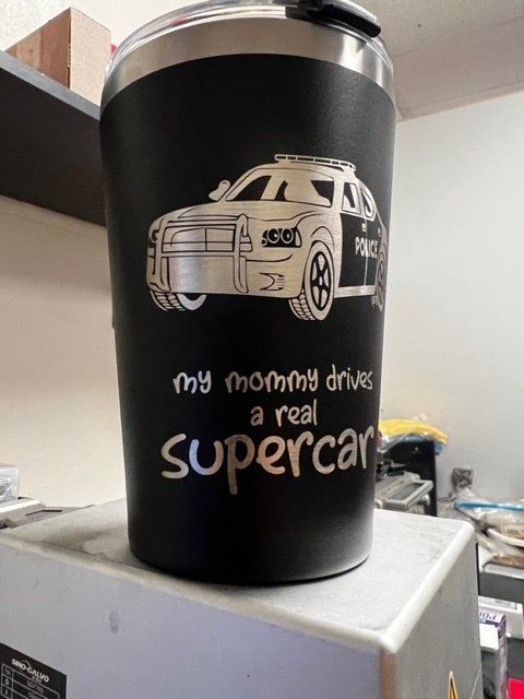 A cup that says my mommy drives a real supercar