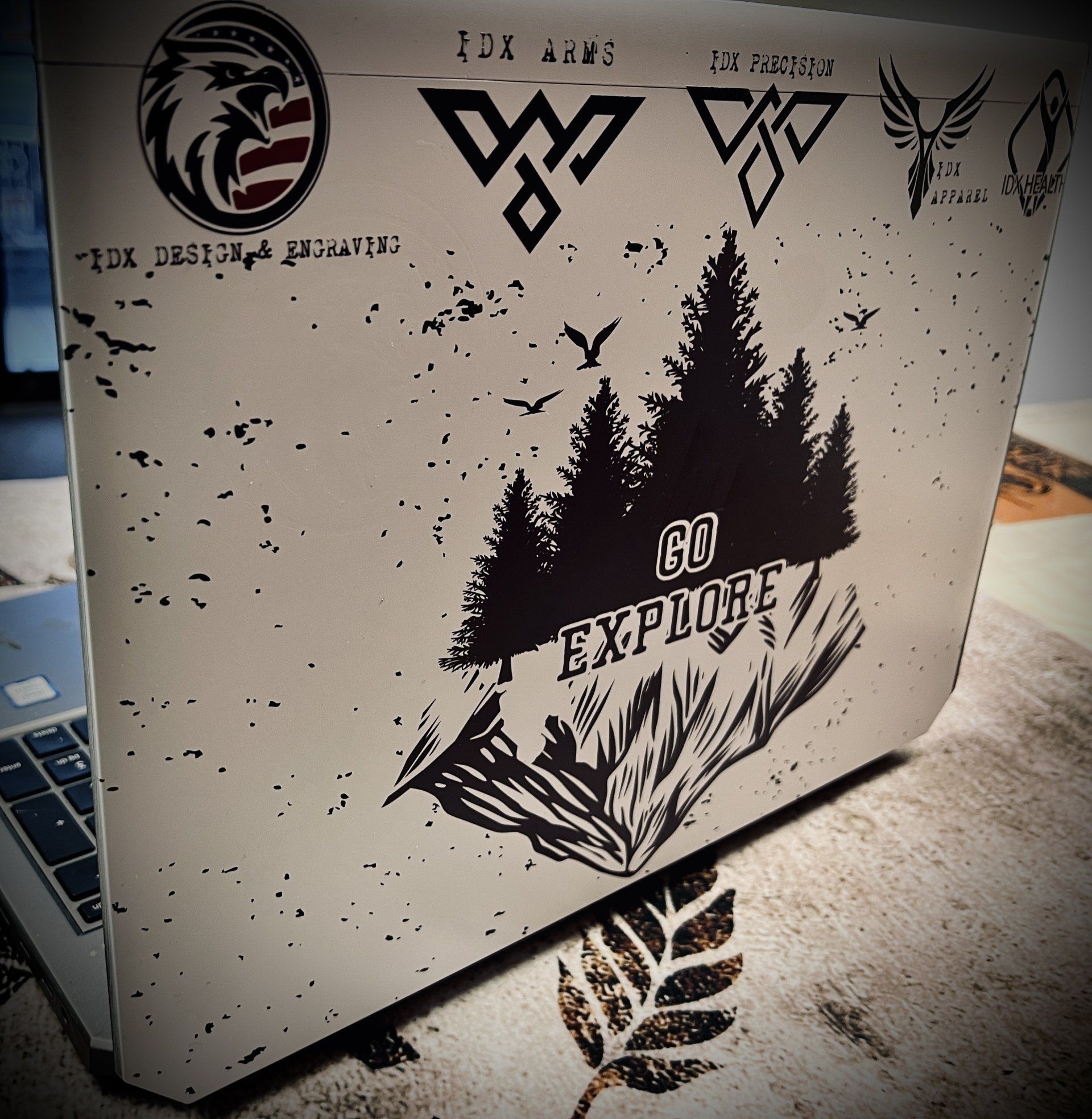 A laptop with a sticker that says go explore