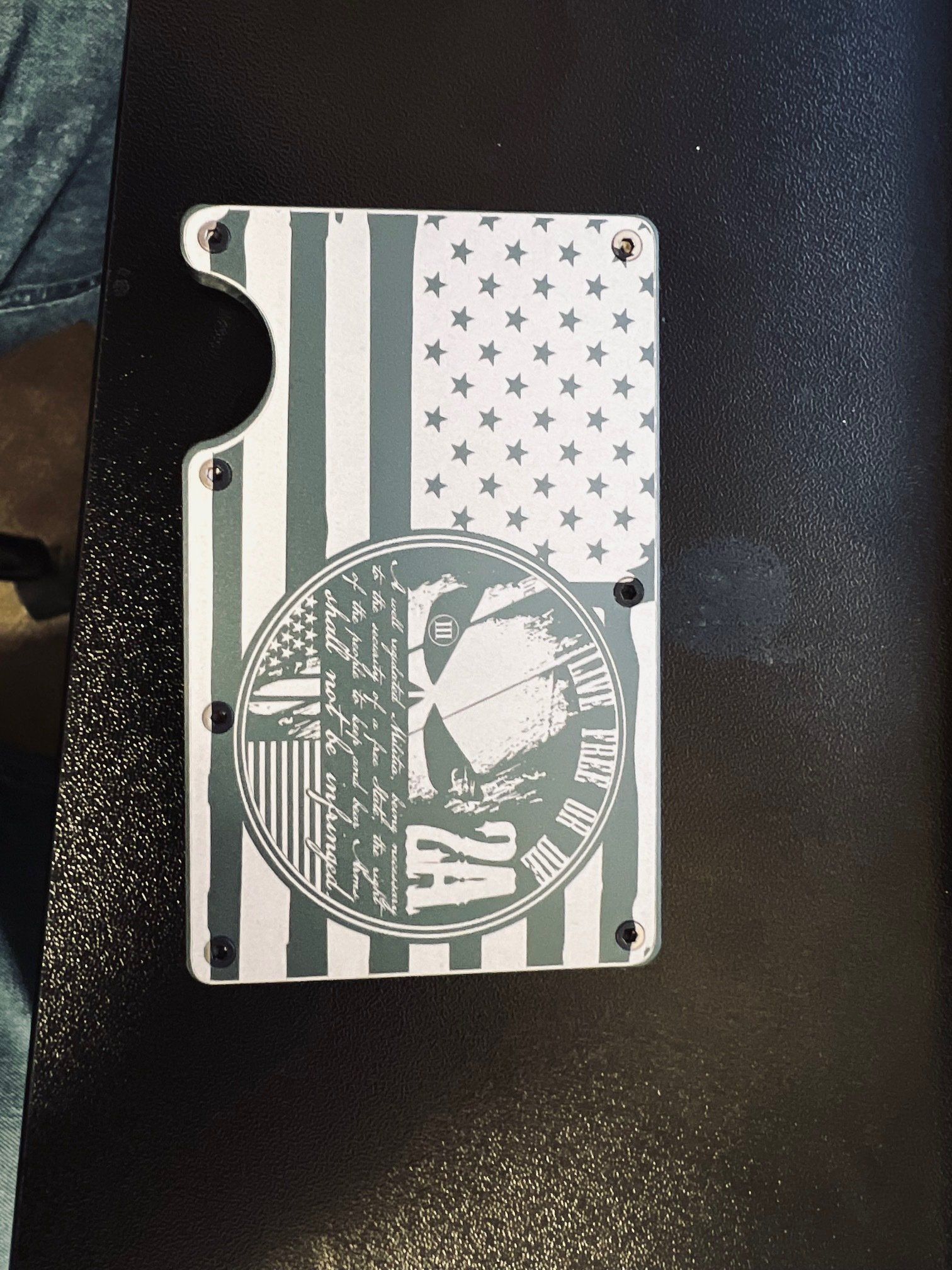 A wallet with an american flag on it is sitting on a table.