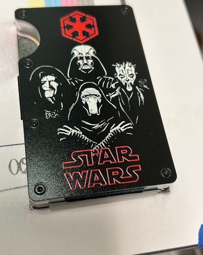 A black star wars wallet is sitting on a table