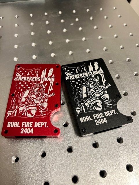 A red and a black wallet are sitting on a table.