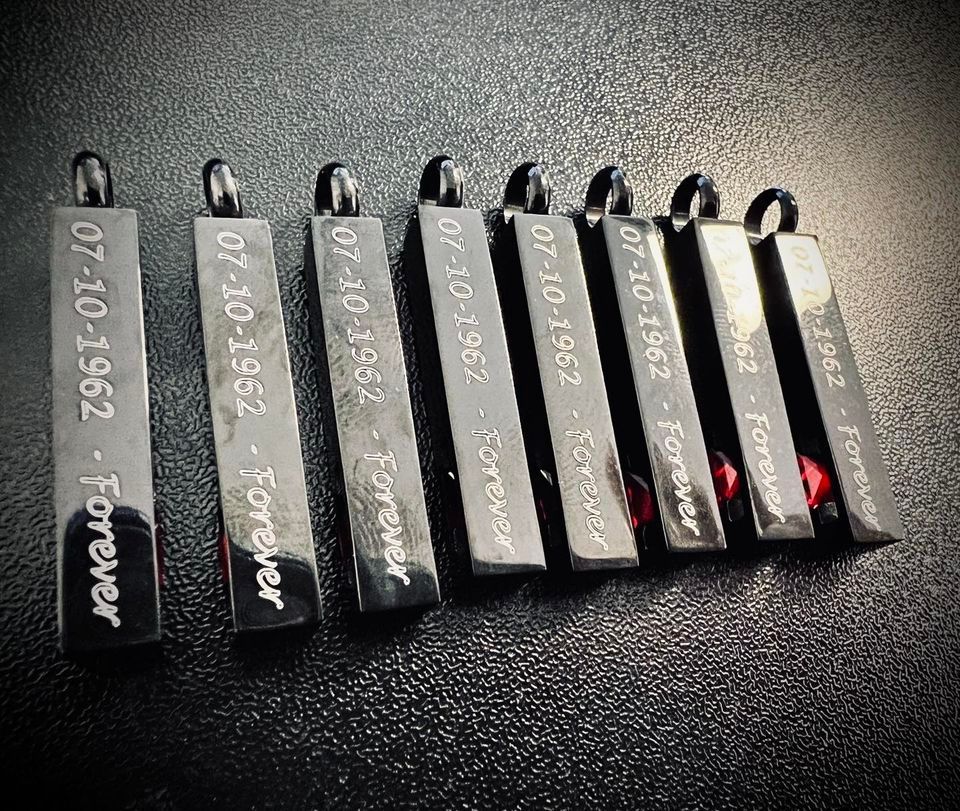 A row of pendants with the words forever engraved on them