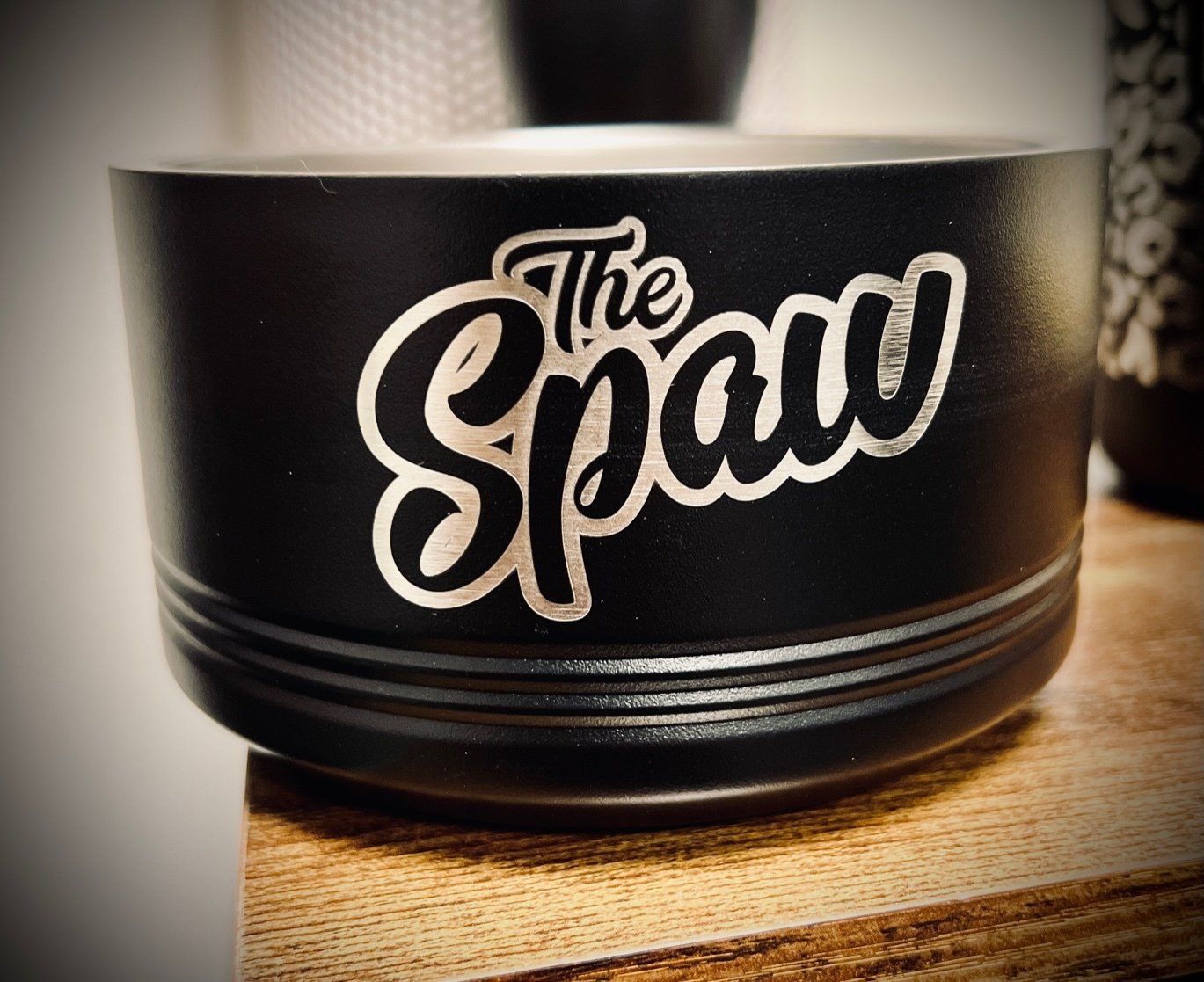 A black bowl with the word the span on it