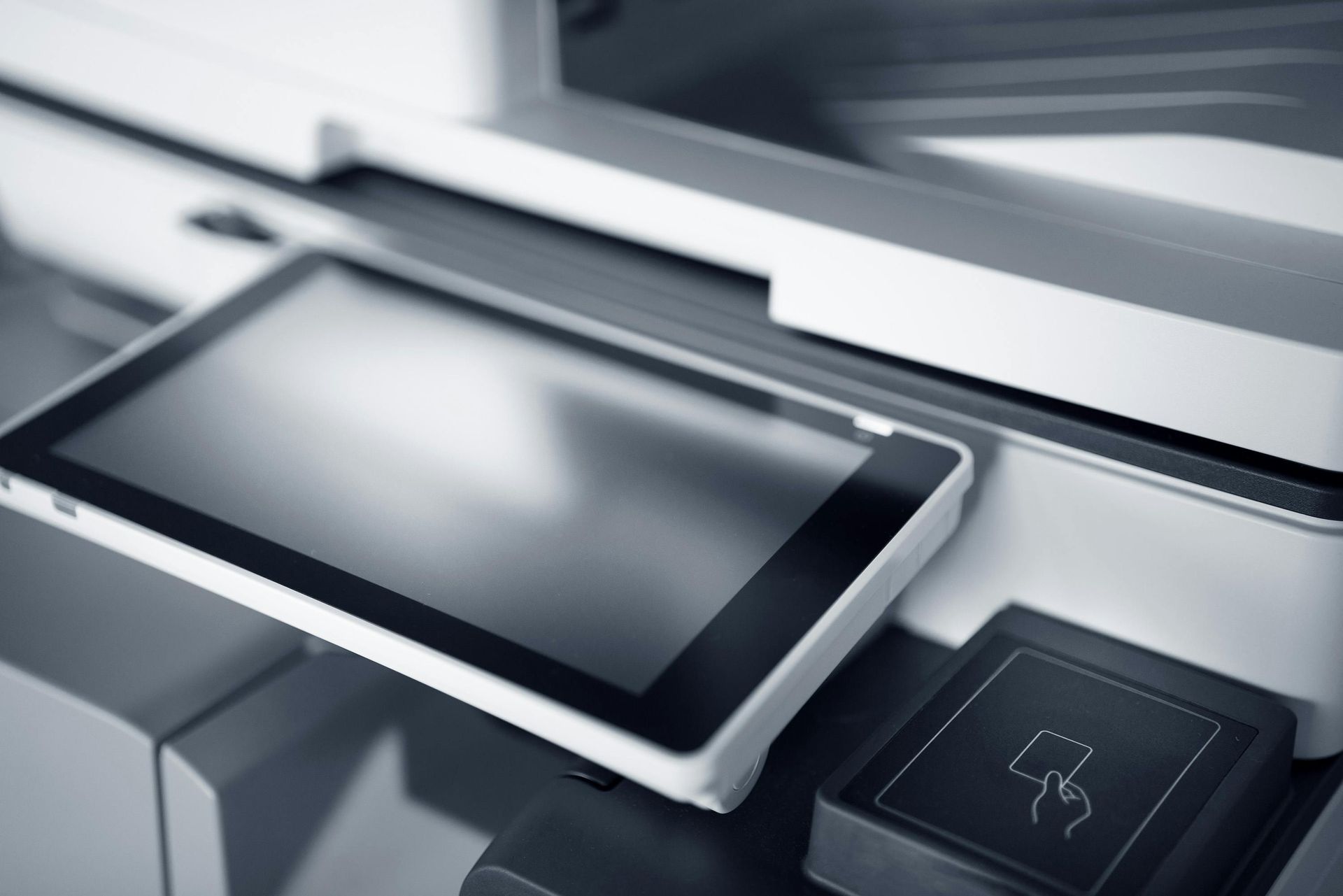 Three different types of printers are sitting next to each other on a table.
