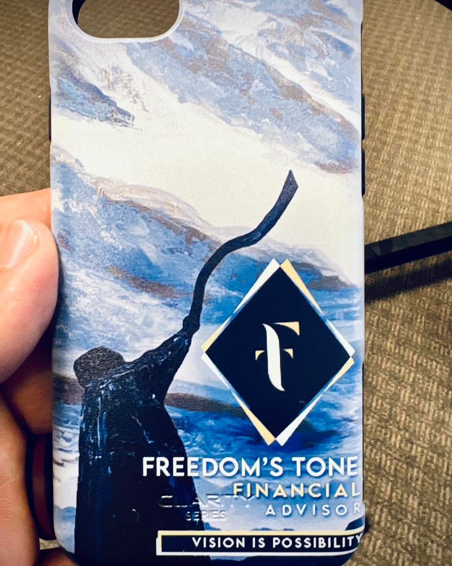 A person is holding a phone case that says freedom 's tone financial advisors