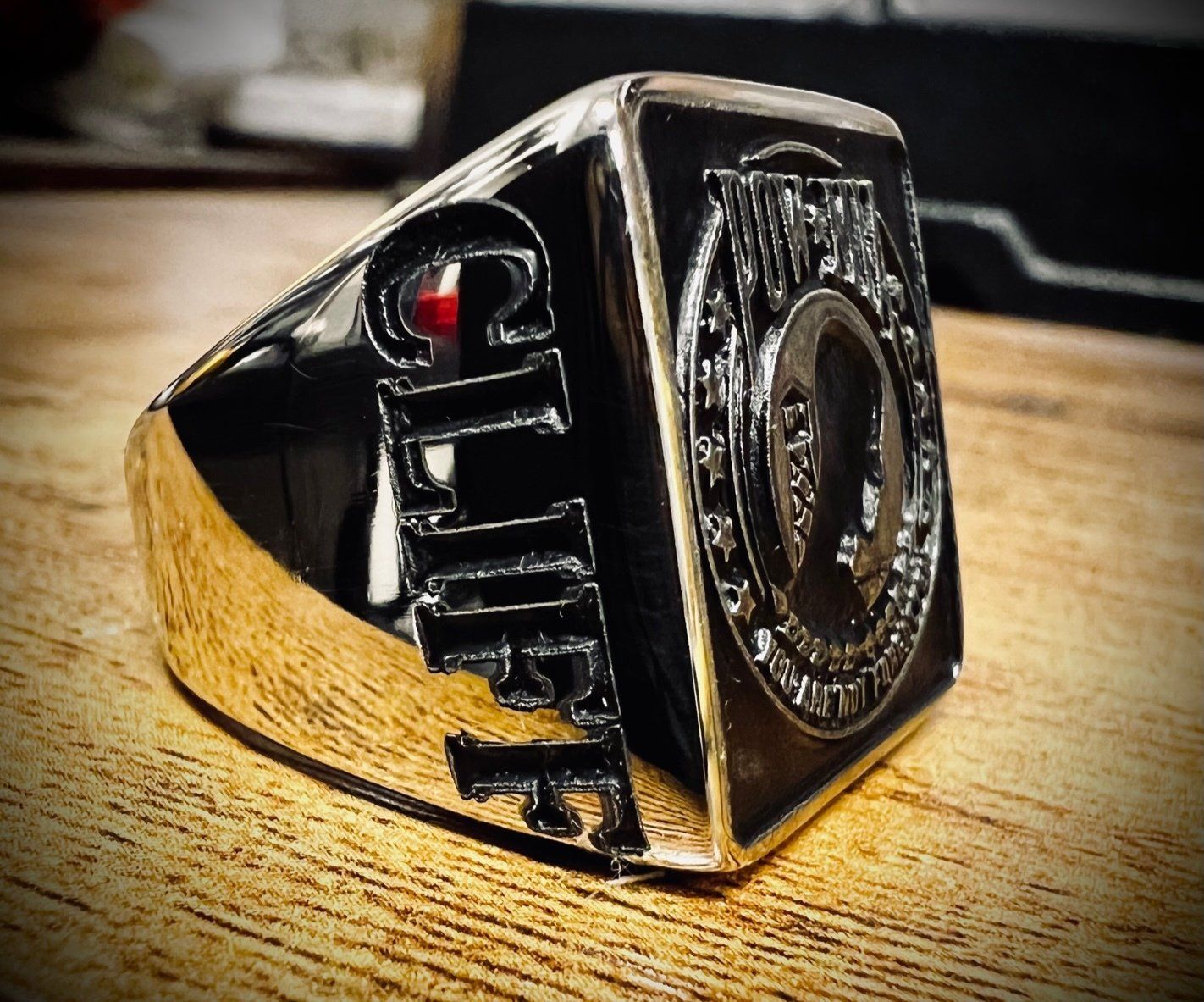 A gold ring with the word cliff on it