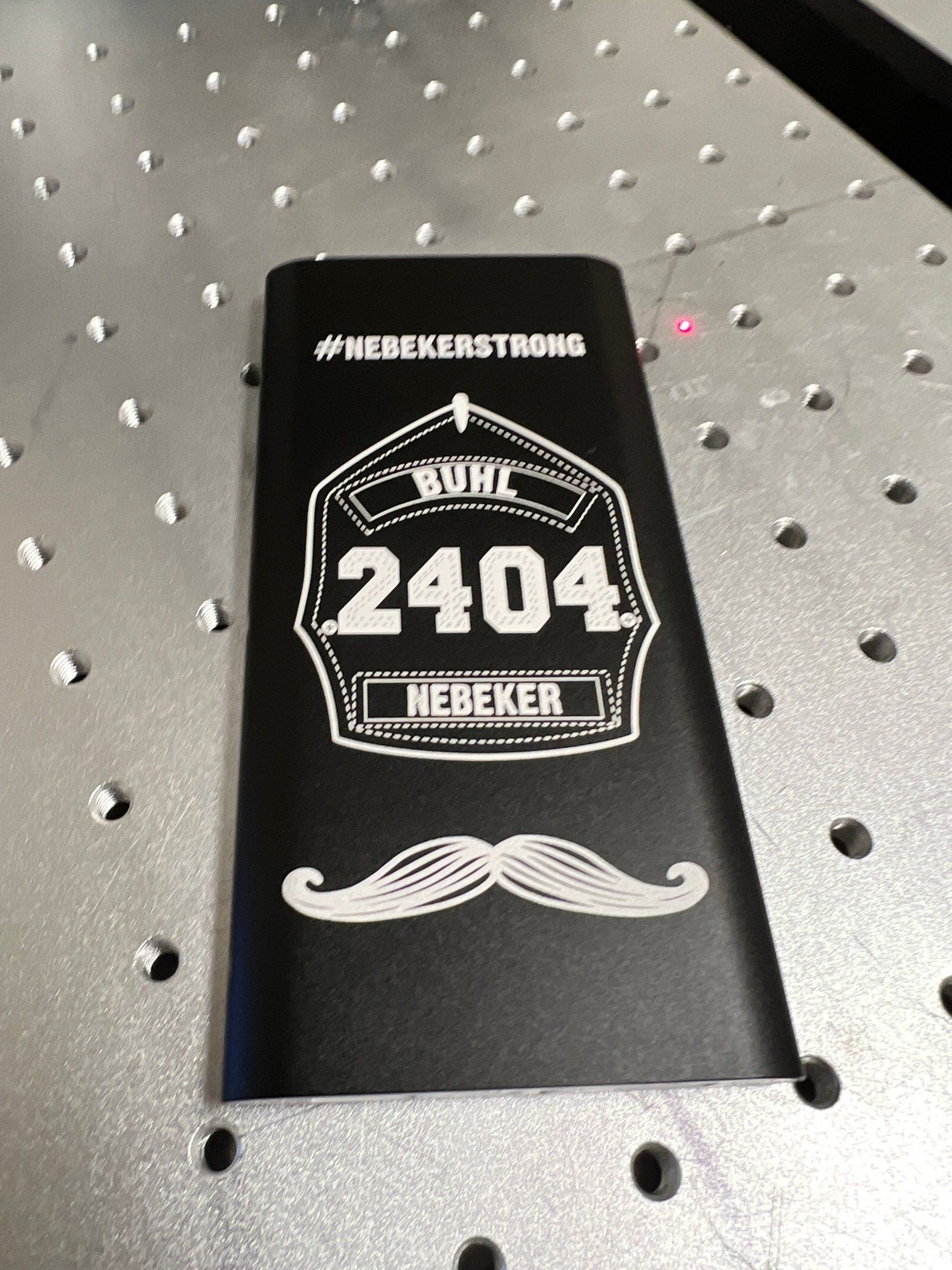 A black item with a mustache on it is on a table.