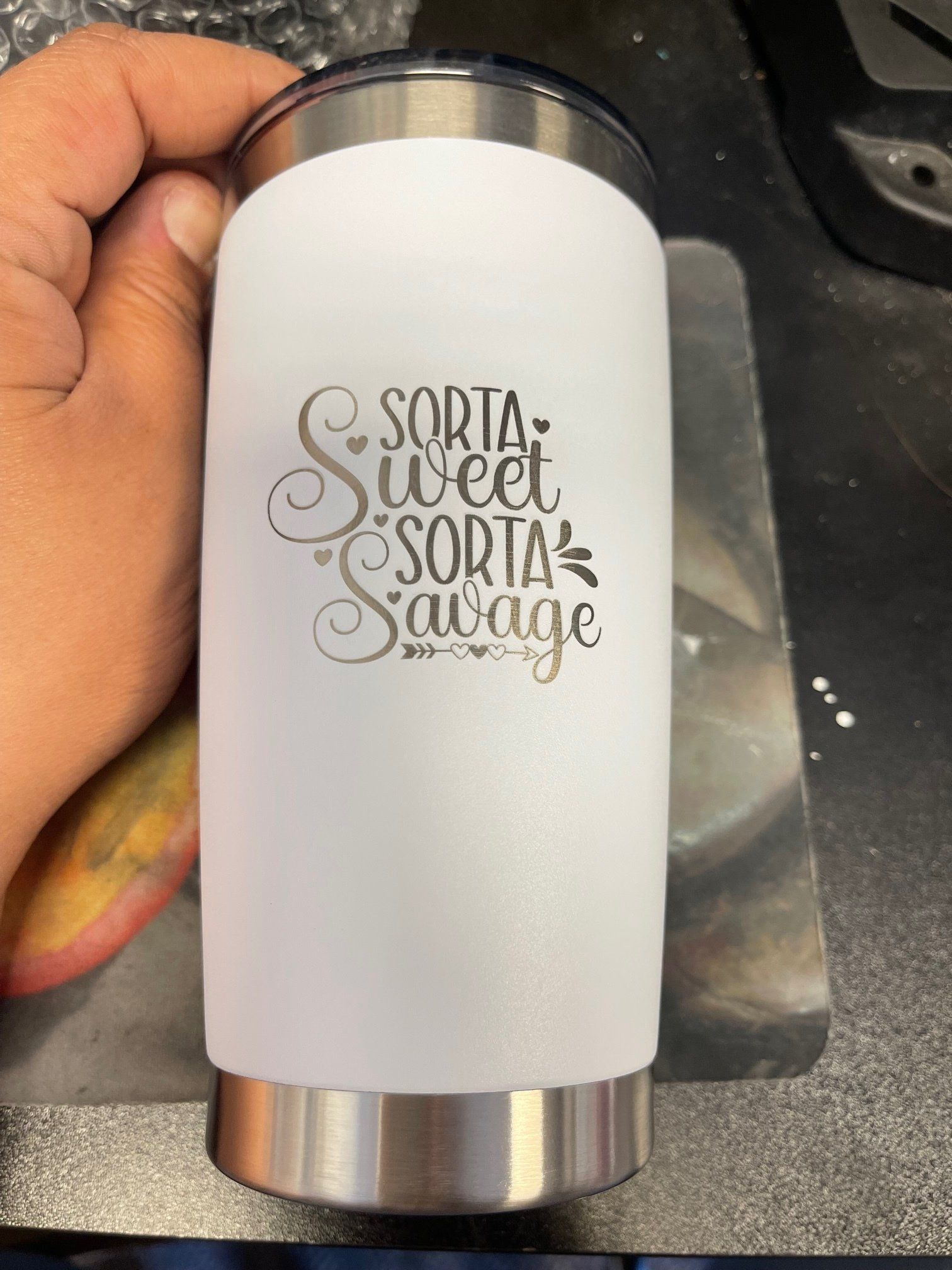 A person is holding a stainless steel tumbler that says sorta sweet sorta savage